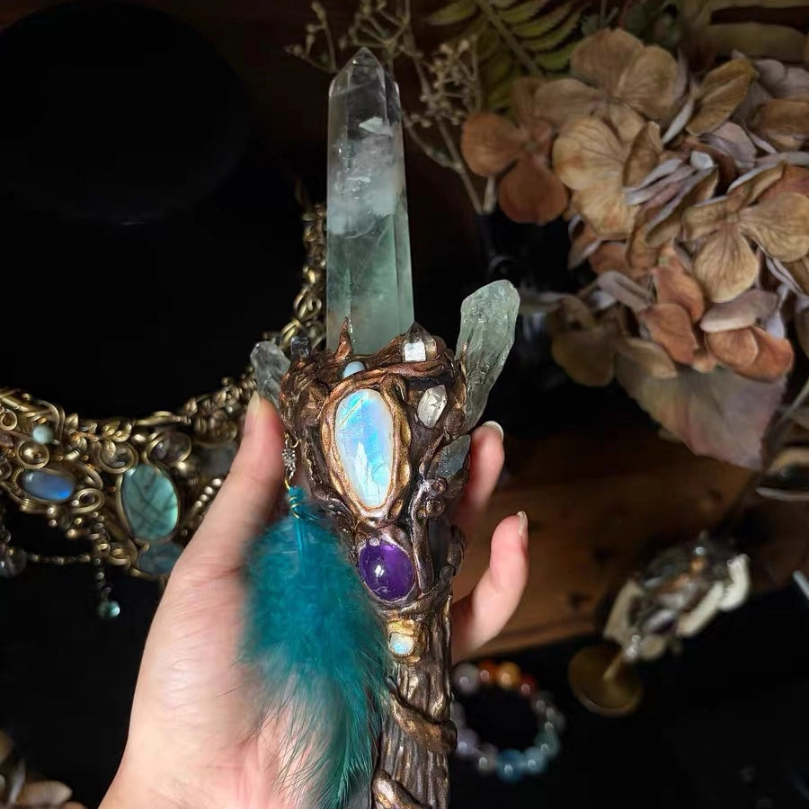 Front view of a handmade crystal antler scepter with moonstone, amethyst, and green crystal details